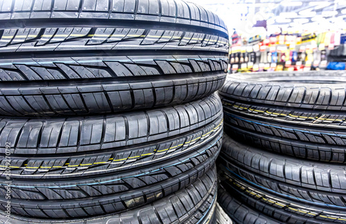 New summer tires stacked up for sale in a superstore