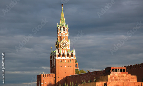 A view of the Moscow Kremlin's Spasskaya Tower and Lenin's Mausoleum against a sky. Red Square in Moscow, Russia