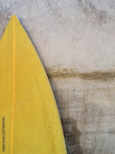 wallpaper of a yellow surf board against a wall