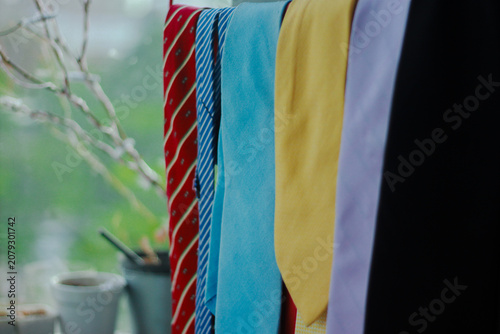Quadro su tela A collection of colorful microfiber cleaning cloths hanging neatly by a window with soft natural light