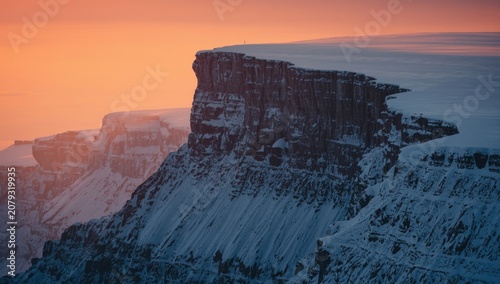 Snow-covered cliff with a s...