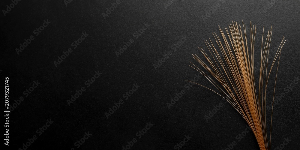 Fototapeta premium Thin Japanese paper fibers visible on a dark black smooth backdrop with copy space