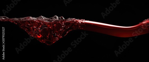 Red liquid swirling in a sm...