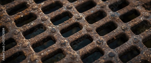Rusty metal grate with a gr...