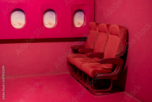 Stylish Pink Aircraft Interior with Passenger Seat. Modern Pink Aircraft Cabin with Empty Seat. Pink Airplane Passenger Seat in a Modern Cabin.