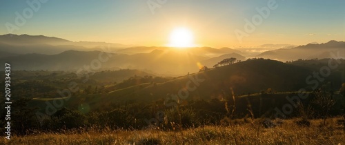 Sunrise over rolling hills ...