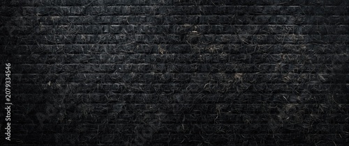 Textured black brick wall b...