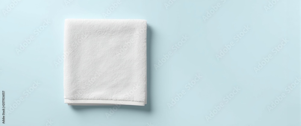 Obraz premium White towel folded on a light blue background