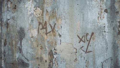 Textured close shot of a weathered concrete wall showing artistic marks and surface flaws