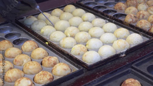 Street vendor is frying traditional Asian rice balls