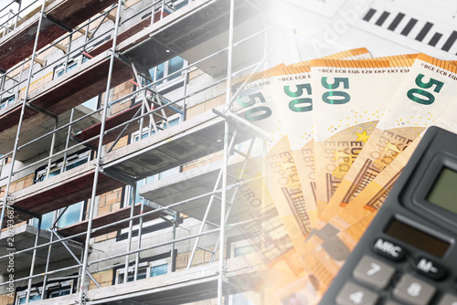Apartment construction remains unfinished. Scaffolding covers raw building. Euro banknotes show higher costs. Calculator helps plan budget. Finance background for housing investment. Property prices.