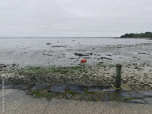 melancholic view of the beach at low tide on a rainy and gray day