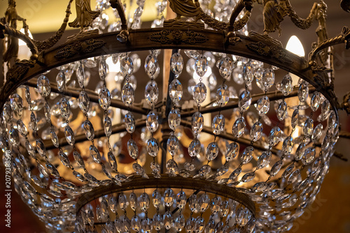 A vintage crystal chandelier, showcasing its opulent design and the play of light through its facets