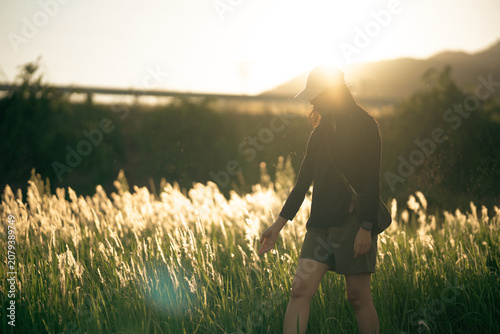 Woman grass field sunset si...