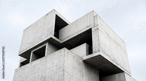 Low angle view of an abstract brutalist concrete gym building exterior.