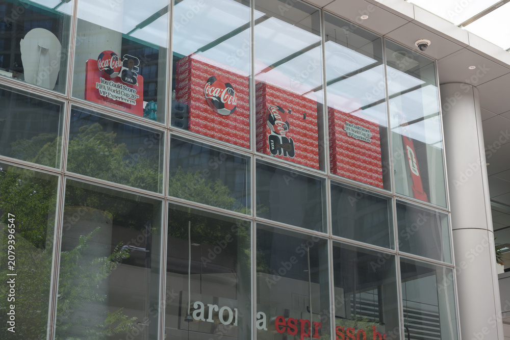 Obraz premium Coca-Cola signs and floor display above sign to Aroma Espresso Bar, a cafe, located here at RBC Water Park Place, 88 Queens Quay W, Toronto