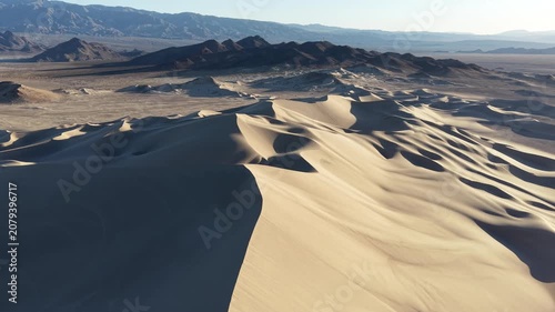 drone fly over of dumont dunes and surrounding mountains in the california mojave desert