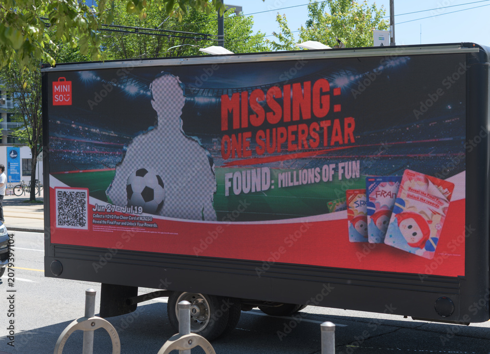 Obraz premium mobile digital billboards or LED billboard trucks with ad for MINISO and soccer, Toronto