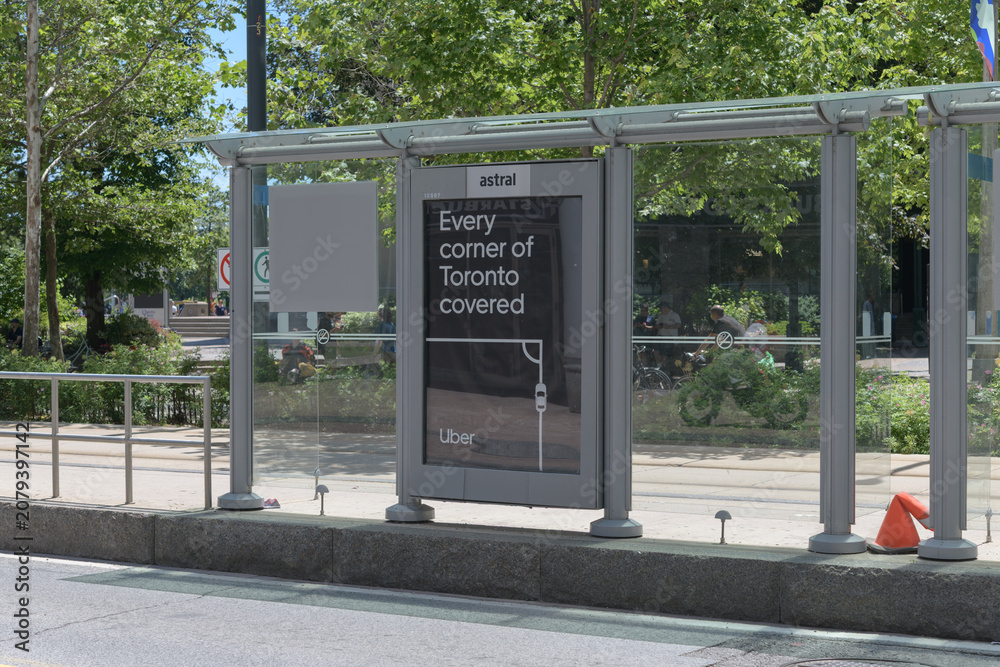 Obraz premium Astral Media (Bell) OOH transit shelter with poster for Uber in Toronto