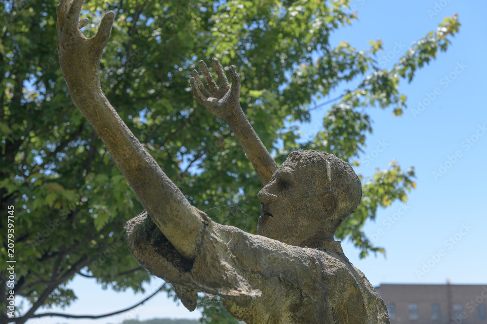 Obraz premium haunting bronze statue (The Jubilant Man) created by Irish sculptor Rowan Gillespie at Ireland Park, a powerful waterfront memorial at Éireann Quay, Toronto