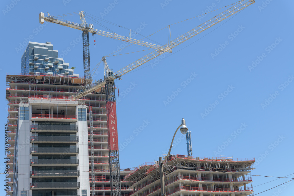 Obraz premium construction of Pinnacle Lakeside Residences at 215 Lake Shore Blvd E - looking east - to construction cranes and banner, Toronto