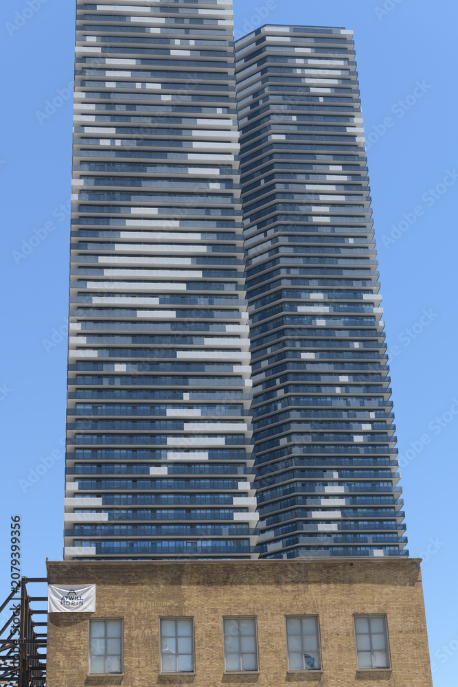 Obraz premium (brick building) former LCBO headquarters at 55 Lake Shore Blvd E and view of Sugar Wharf condominium complex towers, Toronto