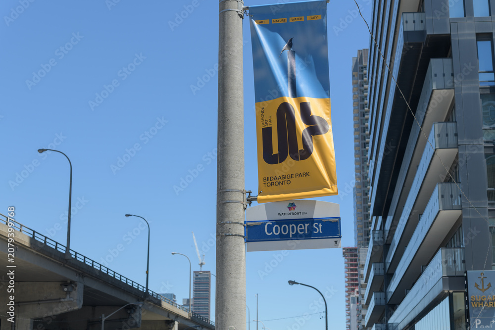 Obraz premium pole-mounted projecting banner of Lassonde Art Trail at Cooper St - looking east on Lake Shore Blvd E, Toronto