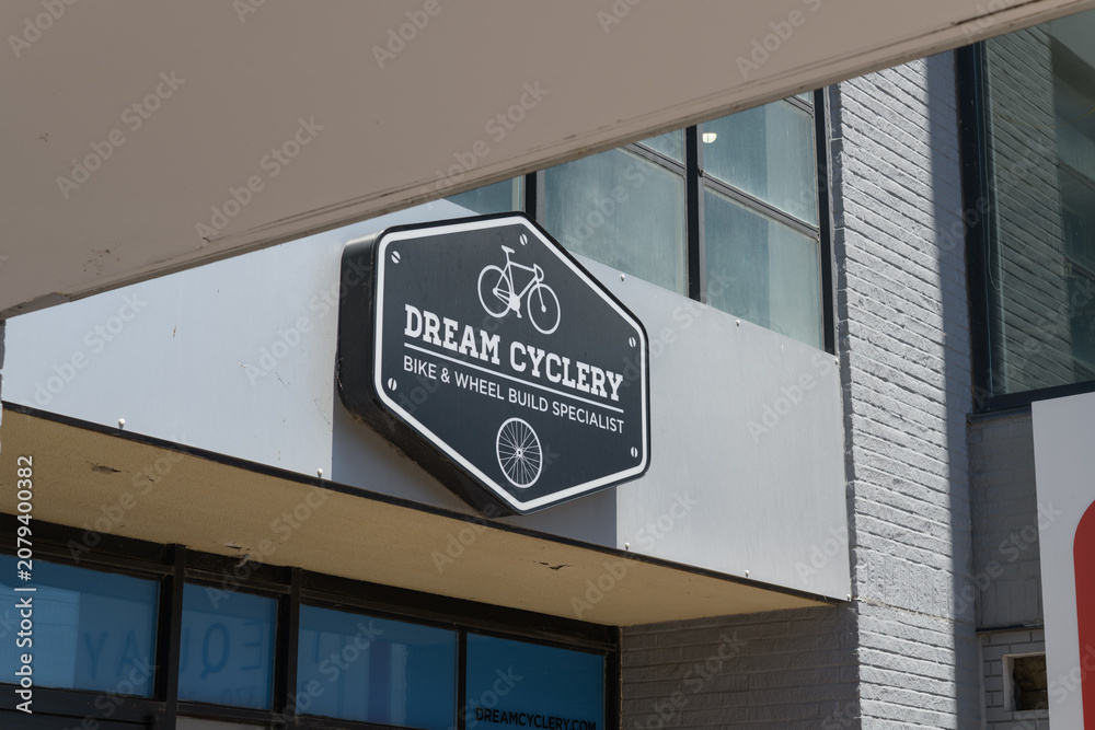 Obraz premium abstract view of building exterior and sign: Dream Cyclery, a bicycle shop, located here at 396 Queens Quay W, inside The Quay, Toronto Waterfront Apartment Rentals