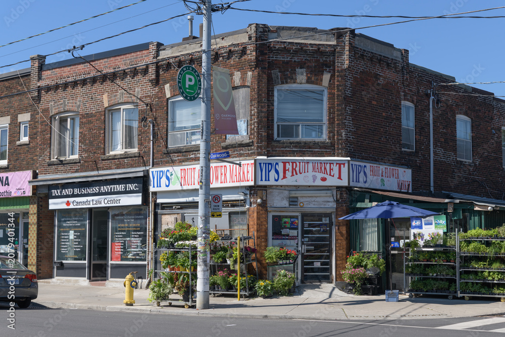 Obraz premium exterior building facade and sign of Yip's Fruit Market located at the southwest corner of 340 Holland Park Av and Oakwood Av, Toronto