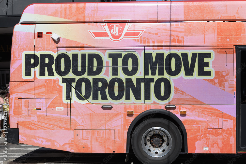 Obraz premium Toronto Transit Commission surface vehicle with slogan at Pride Day parade, Yonge St