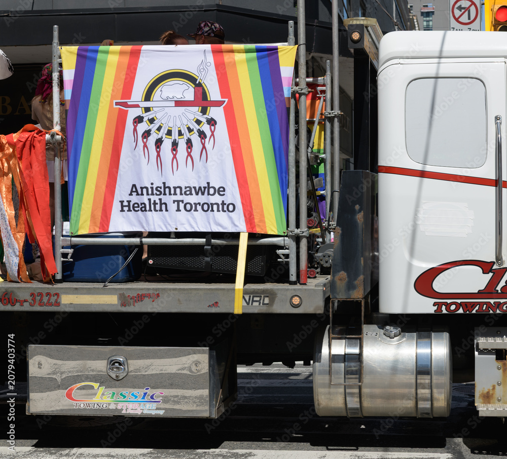 Obraz premium bright rainbow banner on Anishnawbe Health Toronto float at Pride Day parade 2026