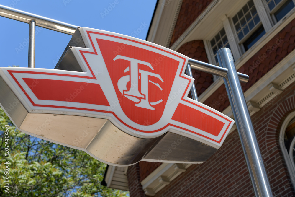 Obraz premium TTC subway station entrance sign outside 85 Spadina Road, formerly Norman B Gash House near Kendal Av, Toronto