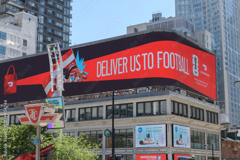 Obraz premium rooftop spectacular with DoorDash advertising (FIFA World Cup 2026 marketing campaign) atop historic building at 279 Yonge St (at Dundas Square), Toronto