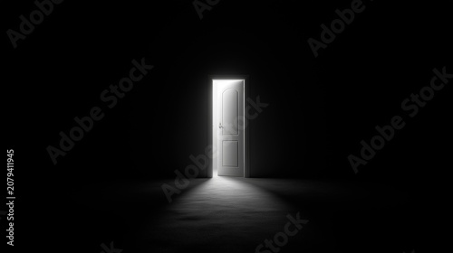 an open white door in a dark empty space.  a dark room with light from an open door