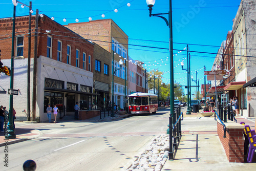 Old Historic Trolley Car on Street Along Brick Buildings in Historical Downtown McKinney, Texas
