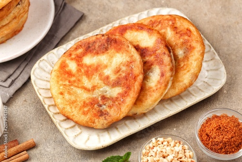 Korean street food hotteok made from sweet dough stuffed with various nuts, sugar and cinnamon.