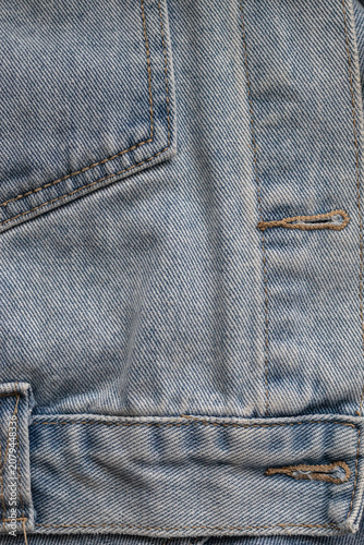 Obraz na plátně Detail view of denim jacket buttonhole and hem