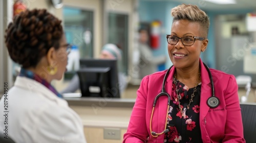 A confident and friendly female medical professional in stylish glasses and a vibrant pink blazer adorned with a stethoscope