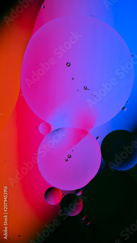 Colorful oil droplets creating abstract fluid art pattern