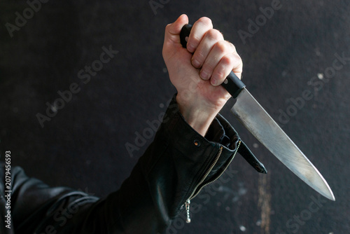 Foto Hand holding sharp knife menacingly.
