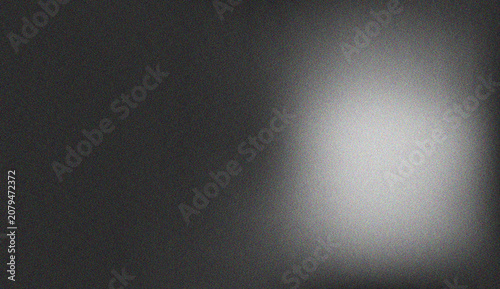 Atmospheric grayscale gradient transitioning from deep dark tones to a soft bright glow with subtle noise texture