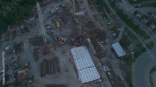 aerial drone view of a large construction site with tower cranes excavators and residential development showcasing urban growth and modern infrastructure
