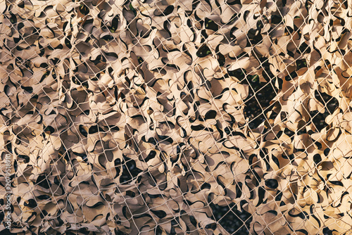 Canvas Print Military camouflage netting forming a protective background pattern, ideal for t
