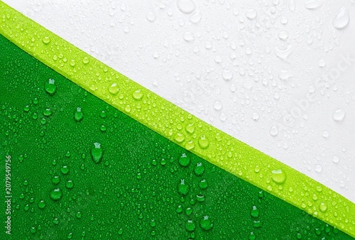 Abstract water drops on vivid green and clean white background, fresh dew droplets texture, nature inspired minimalist design element for eco-friendly concept.