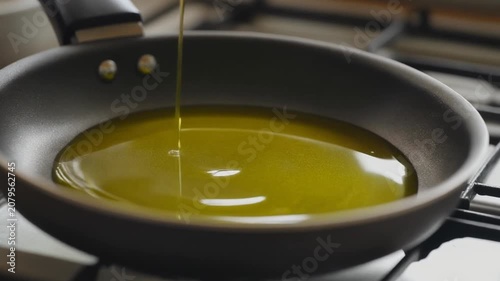 Pouring Olive Oil into Frying Pan for Cooking