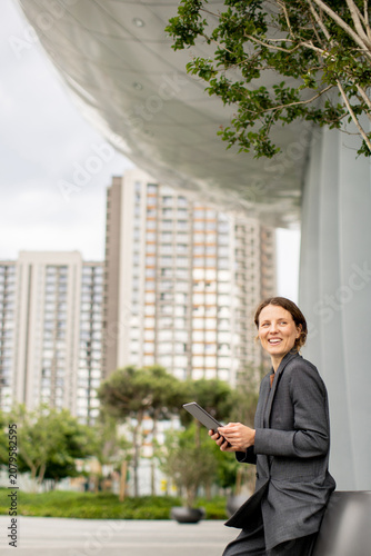 Woman sitting outside using...