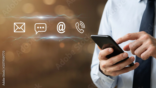 Businessman using a smartphone with floating digital communication icons representing email, chat, and phone calls for global networking