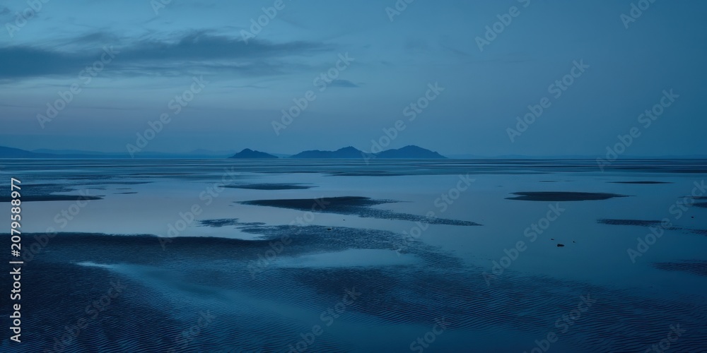 Fototapeta premium Evening light on the water near remote islands at dusk