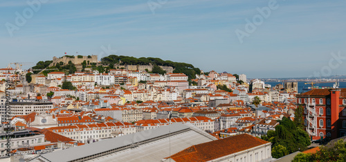 Tableau sur toile Lisbon cityscape spreading down hills towards the tagus river with historical bu