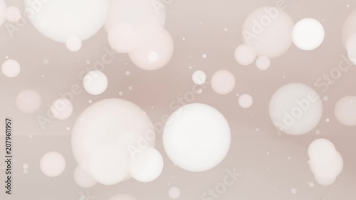 Shifting beige-pink gradient sending bokeh orbs and specks drifting outward in studio adding depth